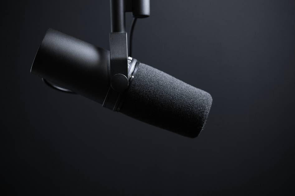 Blogger reviewing podcast equipment in studio