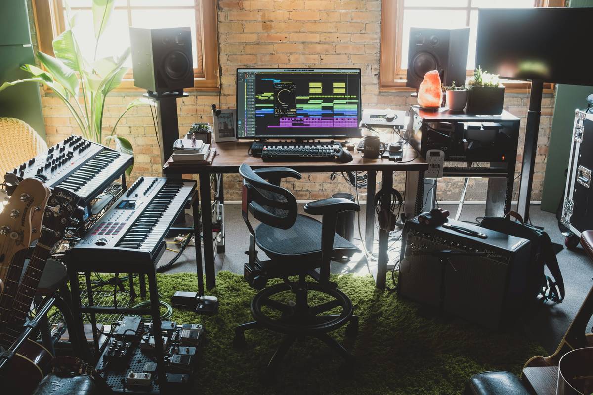 Essential podcast studio equipment list setup with dynamic mic, audio interface, and closed-back headphones on a desk